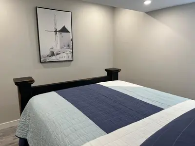 a bedroom with a bed and a picture on the wall at The Croft House - 2 Bedroom 1 Bathroom Suite in Burlington