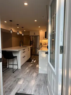 a kitchen with white cabinets and a counter top at The Croft House - 2 Bedroom 1 Bathroom Suite in Burlington