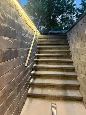 a set of stairs next to a brick wall at The Croft House - 2 Bedroom 1 Bathroom Suite in Burlington