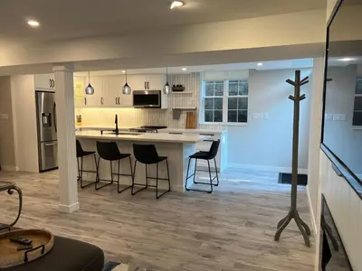a kitchen with a island with bar stools in it at The Croft House - 2 Bedroom 1 Bathroom Suite in Burlington