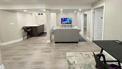 a living room with a couch and a tv in it at Cozy 1.5 Guest-Suite in Aurora