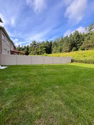 a yard with a fence in front of a house at Cozy 1.5 Guest-Suite in Aurora