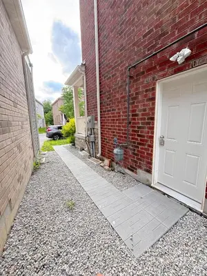a brick building with a white door on the side of it at Cozy 1.5 Guest-Suite in Aurora