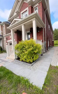 a red brick house with a bush in front of it at Cozy 1.5 Guest-Suite in Aurora