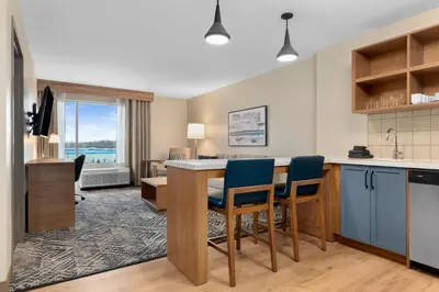 a kitchen and living room with a table and chairs at Candlewood Suites Collingwood by IHG in Collingwood