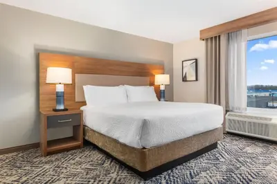 a hotel room with a bed and a window at Candlewood Suites Collingwood by IHG in Collingwood