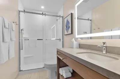 a bathroom with a sink and a shower at Candlewood Suites Collingwood by IHG in Collingwood