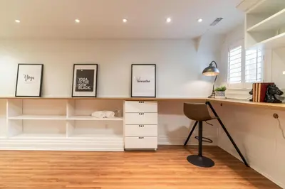 a home office with a desk and a chair at Beautiful 3BR House in the Heart of Greek Town in Toronto