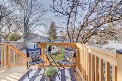a patio with two chairs and a table on a fence at Beautiful 3BR House in the Heart of Greek Town in Toronto