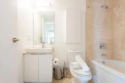 a bathroom with a toilet and a sink and a tub at Beautiful Luxurious Modern Condo With Breathtaking Views in Toronto