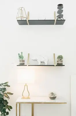 a table with two shelves on the wall with plants at Beautiful Luxurious Modern Condo With Breathtaking Views in Toronto