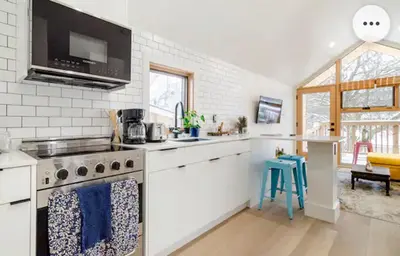 a kitchen with a stove and a counter top at Tiny House Haven in Peterborough