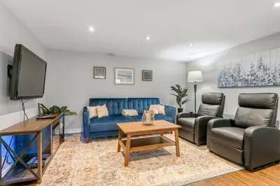 a living room with couches and a flat screen tv at Lakeside Retreat near Toronto in Mississauga