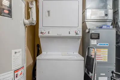a washer and dryer in a room next to a refrigerator at Quite in Nature in Edgar