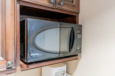 a microwave oven sitting in a wooden cabinet at Quite in Nature in Edgar