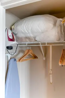 a shelf with a pillow and hangers in a closet at Quite in Nature in Edgar