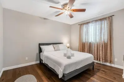 a bedroom with a bed and a ceiling fan at Fun & Cozy Retreat: Nature & Games in Trenton