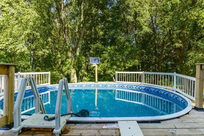 a swimming pool with a slide in a yard at Fun & Cozy Retreat: Nature & Games in Trenton