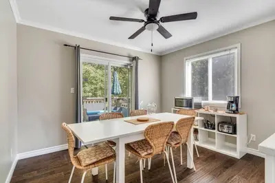 a dining room with a white table and chairs at Fun & Cozy Retreat: Nature & Games in Trenton