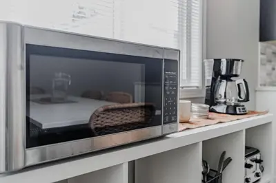a microwave sitting on a counter in a kitchen at Fun & Cozy Retreat: Nature & Games in Trenton