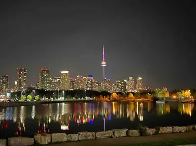 a view of a city at night with the cn tower at King West Private Rooftop Retreat in Toronto