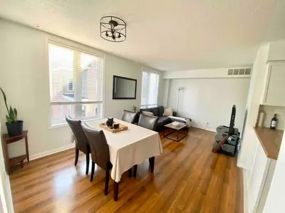 a living room with a table and chairs and a couch at King West Private Rooftop Retreat in Toronto