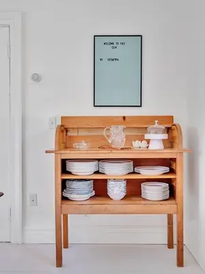 a wooden shelf with plates and a picture on it at The Gem - Beautiful farmhouse with hot tub in West Lake