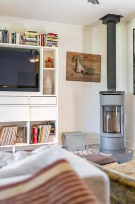 a living room with a fireplace and a tv at Away in the County-Sandbanks Pec in Cherry Valley