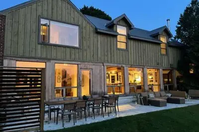 a house with a table and chairs in front of it at Away in the County-Sandbanks Pec in Cherry Valley