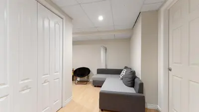 a living room with a couch and a door at Finished 2 BR Apartment in an Upscale Area of Ajax in Ajax