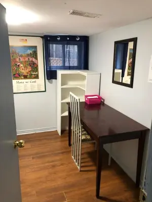 a dining room with a table and a chair at Angelina’s house in Toronto