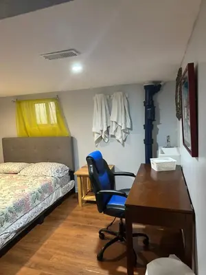 a bedroom with a desk and a bed and a chair at Angelina’s house in Toronto