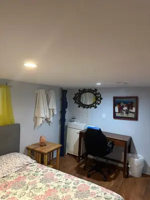 a bedroom with a bed and a desk and a chair at Angelina’s house in Toronto