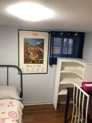 a small bedroom with a bunk bed and a staircase at Angelina’s house in Toronto