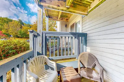 two chairs and a table on a porch at Condo 708 at North Creek Resort in Blue Mountains