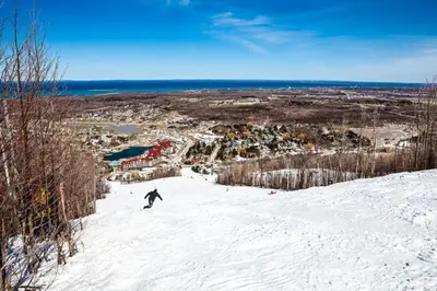 a person riding a snowboard down a snow covered slope at Condo 708 at North Creek Resort in Blue Mountains