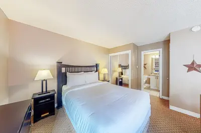 a bedroom with a large bed and a bathroom at Condo 708 at North Creek Resort in Blue Mountains