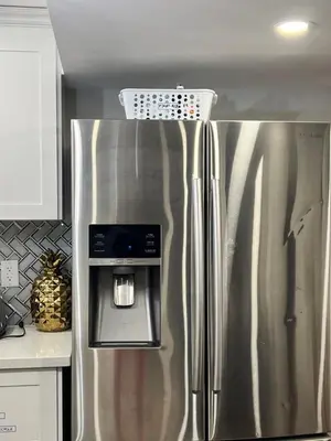 a stainless steel refrigerator with a basket on top of it at Tosam Luxury Lodge Two Bedroom Suite in Brampton