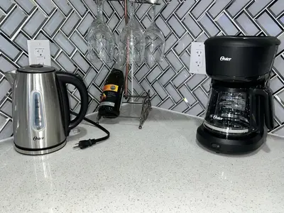 a coffeemaker and a coffee maker on a counter at Tosam Luxury Lodge Two Bedroom Suite in Brampton