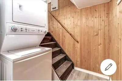 a small kitchen with a stove and a staircase at Affordable stay near the OPG TV and parking in Pickering