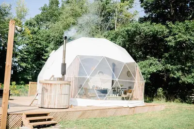 a dome tent with smoke coming out of it at Open Sky Glamping Kawartha Dome in Marmora