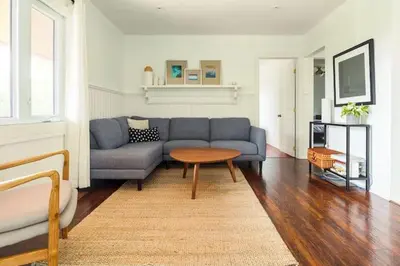 a living room with a couch and a table at Grays Lane - Minutes to Sandbanks in Bloomfield