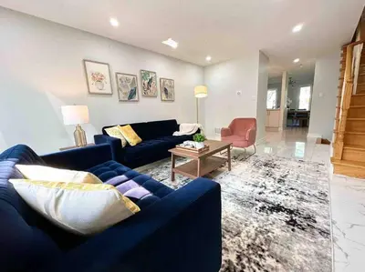 a living room with a blue couch and a table at Charming Home in Prime Location North of Toronto in Richmond Hill
