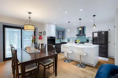 a kitchen and dining room with a table and chairs at N7 Castle Green Retreat-Hot Tub in Toronto