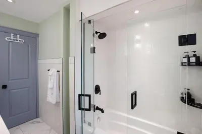 a bathroom with a shower with a glass door at N7 Castle Green Retreat-Hot Tub in Toronto