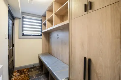 a walk in closet with a bench in a room at N7 Castle Green Retreat-Hot Tub in Toronto