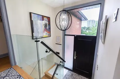 a glass door leading into a room with a glass staircase at N7 Castle Green Retreat-Hot Tub in Toronto