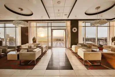a waiting room with chairs and tables and windows at Liberty Suites in Thornhill