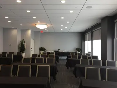 a conference room with chairs and a projection screen at Liberty Suites in Thornhill