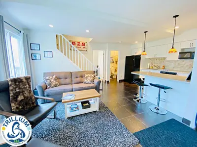 a living room with a couch and a table at Blue Mountain Suites in Blue Mountains